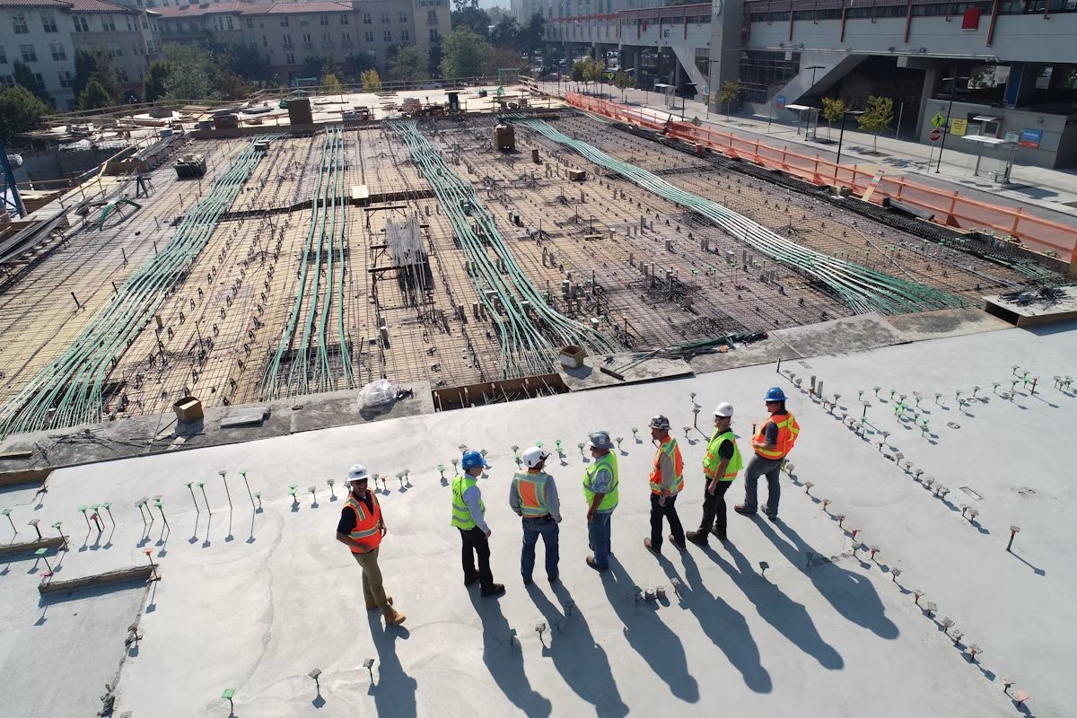 Construction workers pouring concrete on site